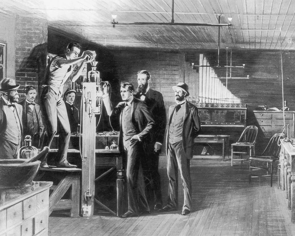 Illustration of Edison and his team experimenting with light bulbs