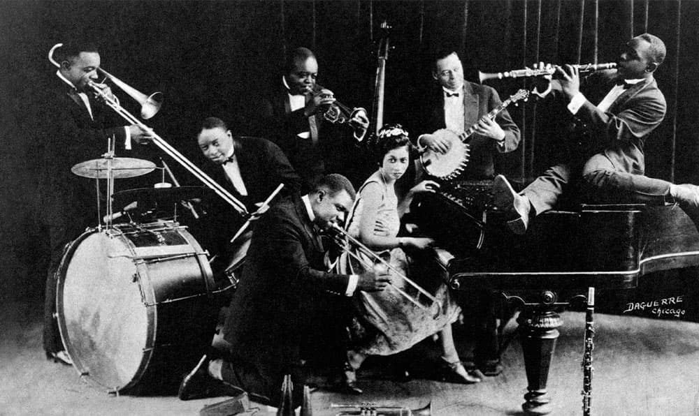 Black & white photo of Armstrong performing with King Oliver's Creaole Jazz Band