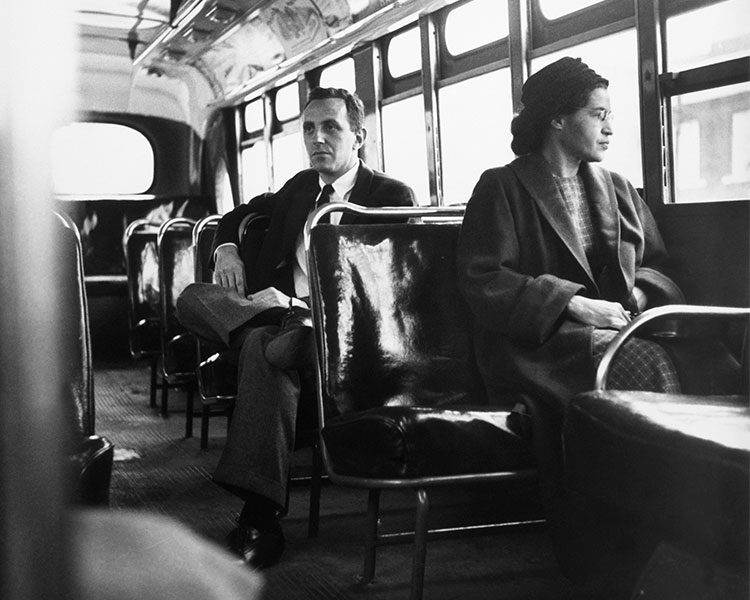 Rosa Parks sitting on the bus in front of a white man