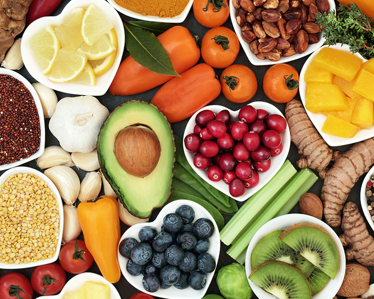 An arrangement of fruits, vegetables, nuts, and roots.