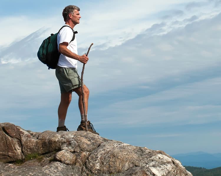 Person hiking on top of a mountain