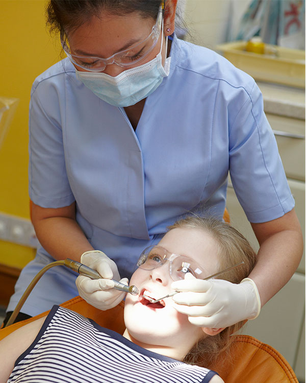 A dentist checking for cavities