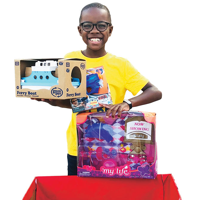 Enlargeable image of a kid donating toys