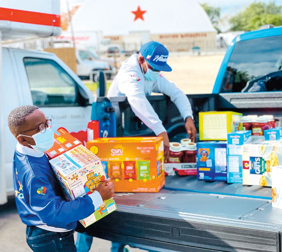 Father and son loading their truck with donations