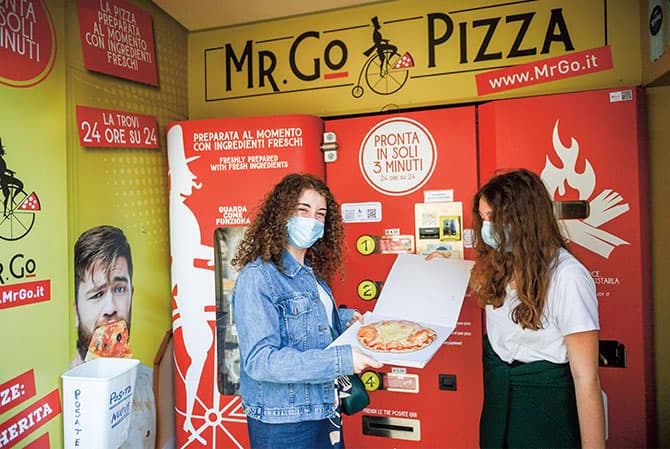 Enlargeable photo of customers holding a pizza.