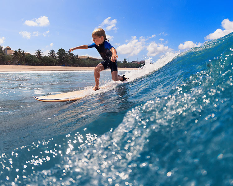 Child surfing in the ocean