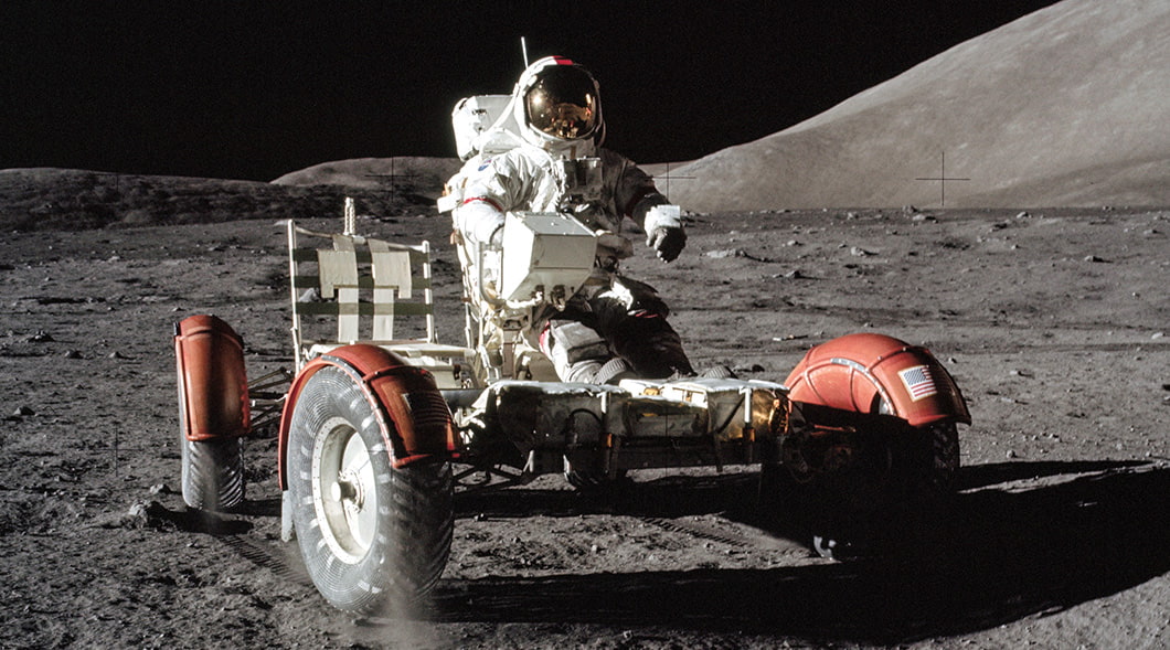 Image of an astronaut riding a moon rover on the moon