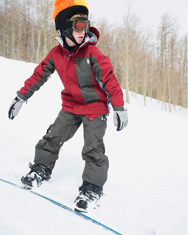 Photo of a kid snowboarding