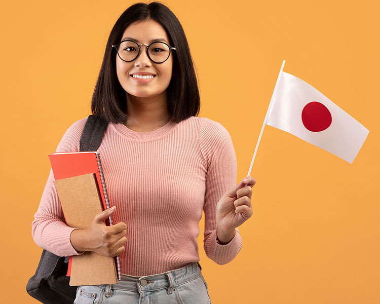 Image of a student holding books and the flag of Japan