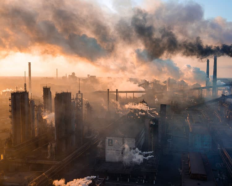 Image of a city with buildings emitting pollution