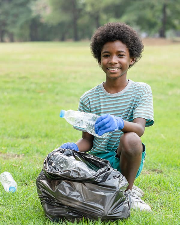 Photo of a person recycling used plastic water bottles in a park