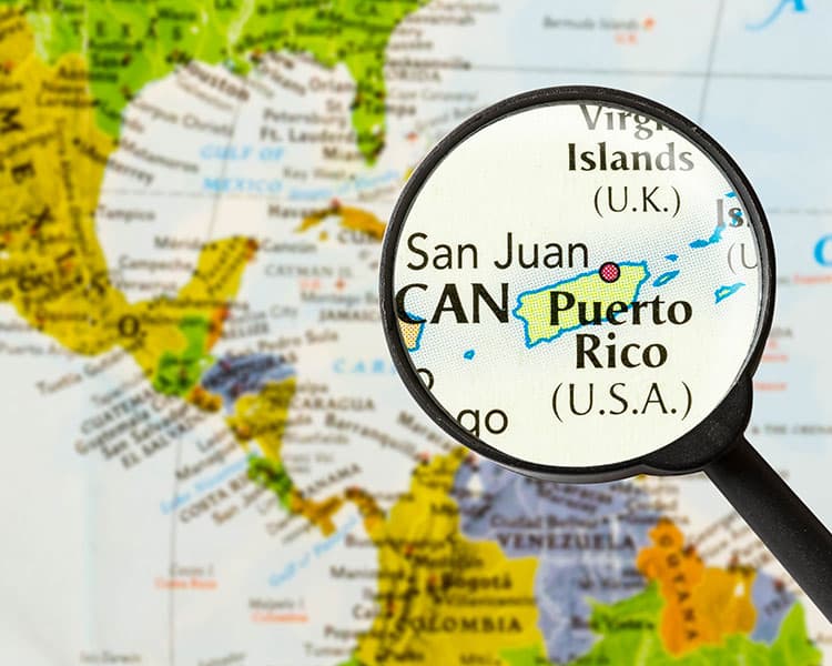 Map with a magnifying glass emphasizing San Juan, Puerto Rico