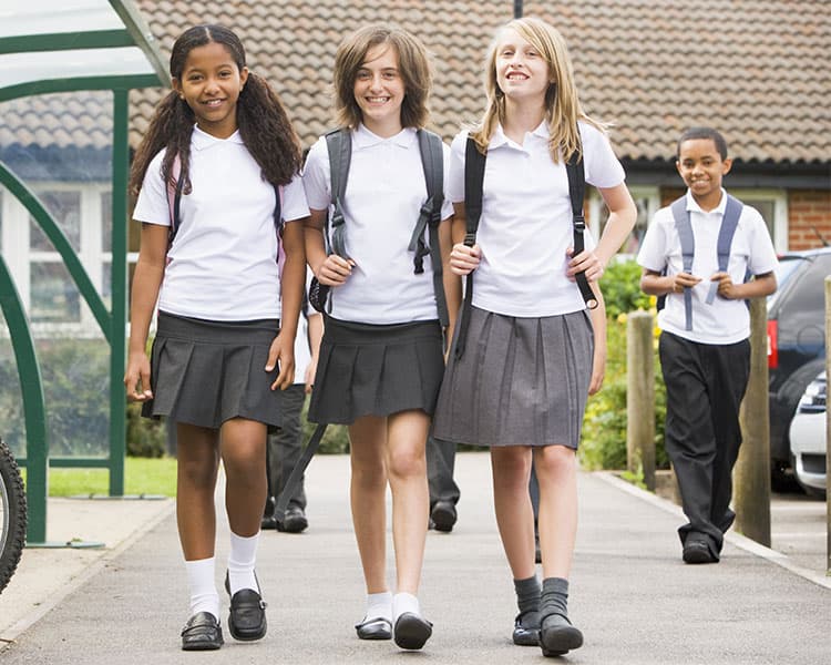 Students wearing matching uniforms walking