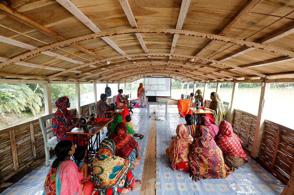 Students gathered inside a school built on the water