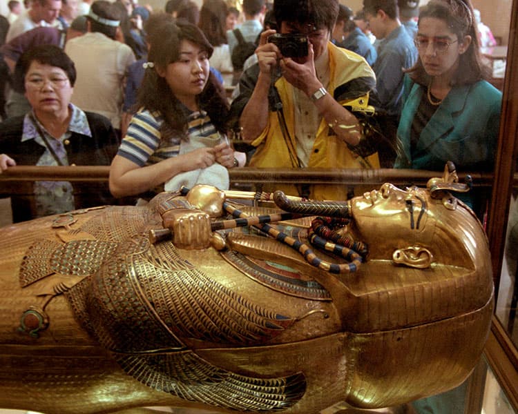 People observing the golden tomb of an Ancient Egyptian Pharaoh