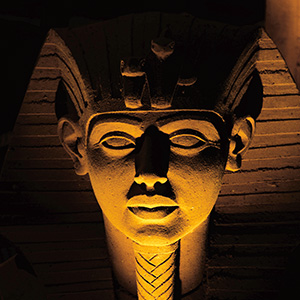 Ancient Egyptian pharaoh carved from stone with an underlight