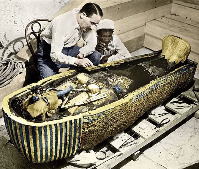 Enlargeable colorized image of two people analyzing a pharaoh&apos;s tomb