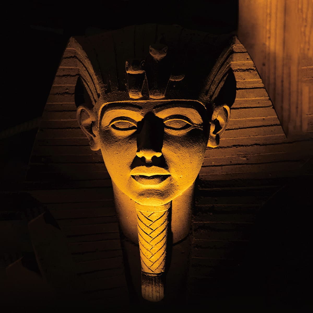 Ancient Egyptian pharaoh carved from stone with an underlight