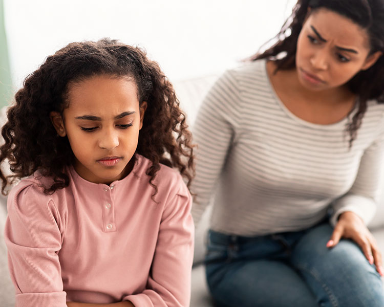 Photo of an upset child and a concerned mother