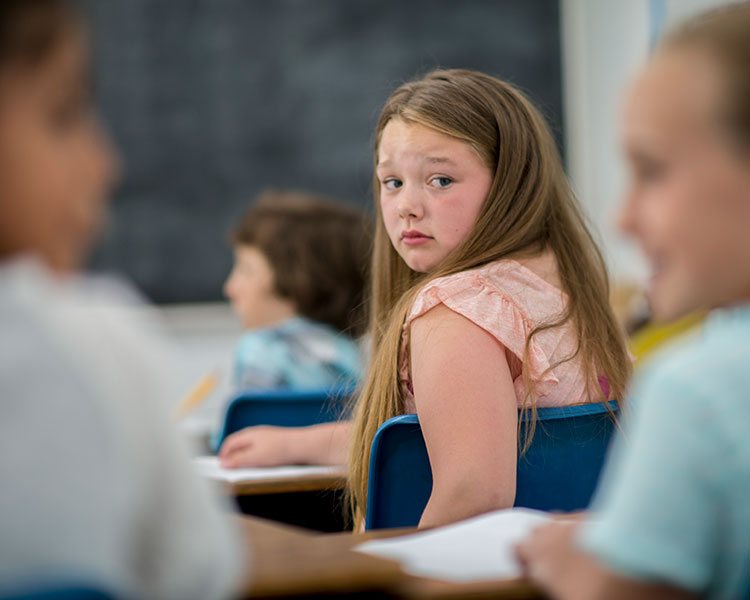 Photo of a student looking worried and turning to look behind them