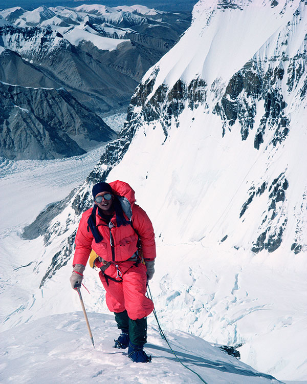 Image of a person climbing up a snowy mountain