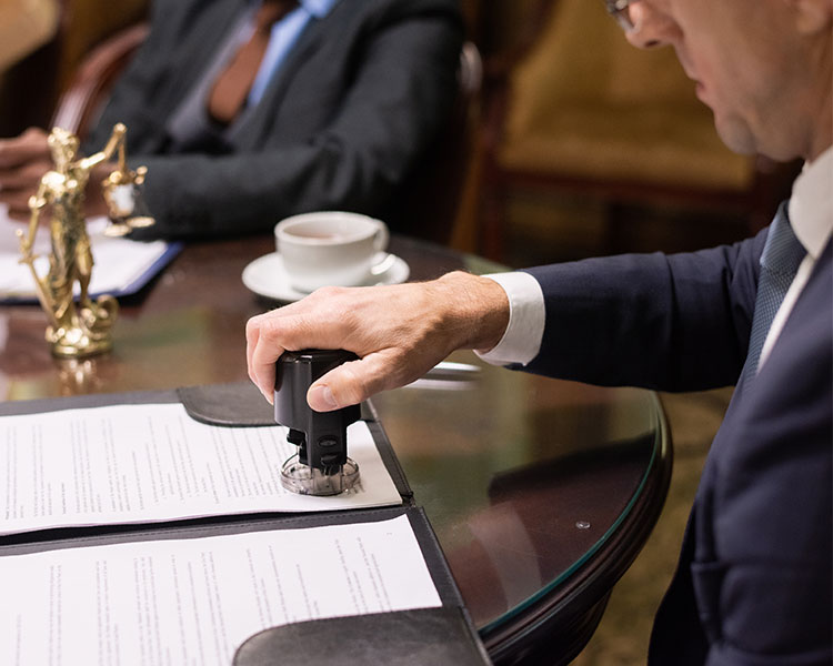 Image of a politician stamping an official document