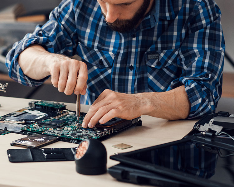 Photo of a person fixing the inside of a computer