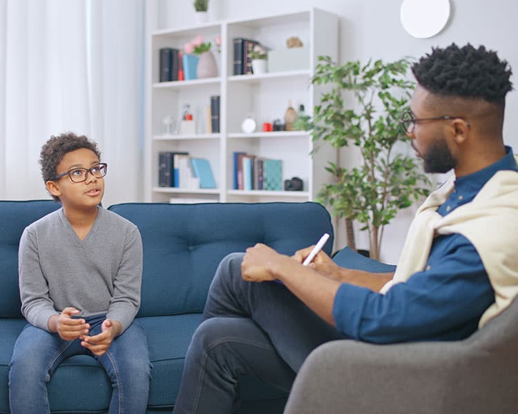 Image of a psychologist talking with a young person