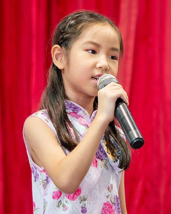 Image of a kid singing into a microphone