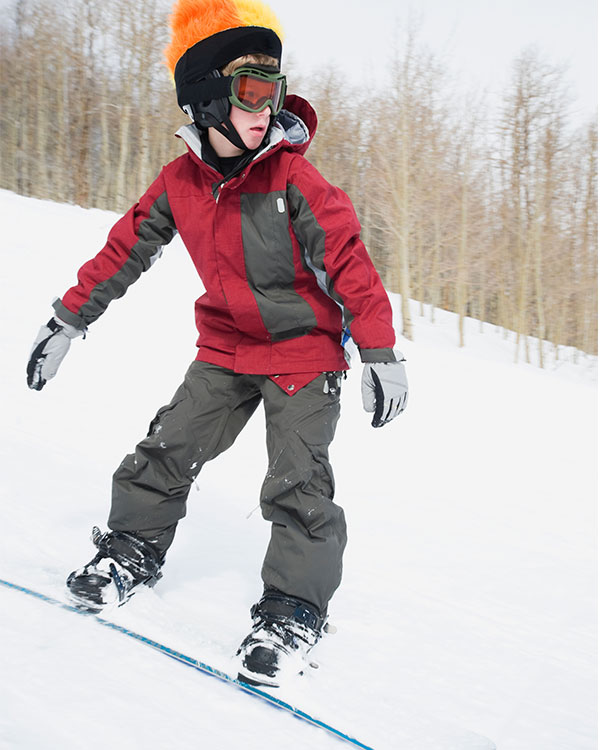 Photo of a kid snowboarding