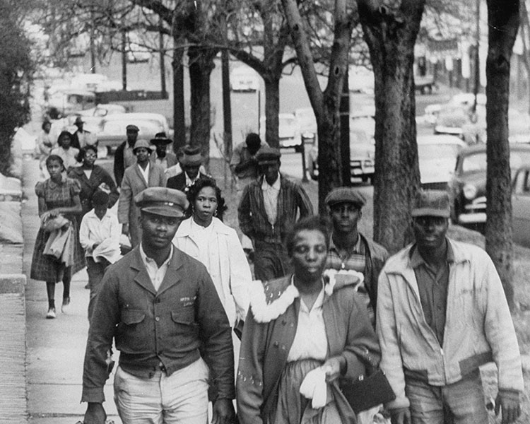 Back & white photo of people marching in protest