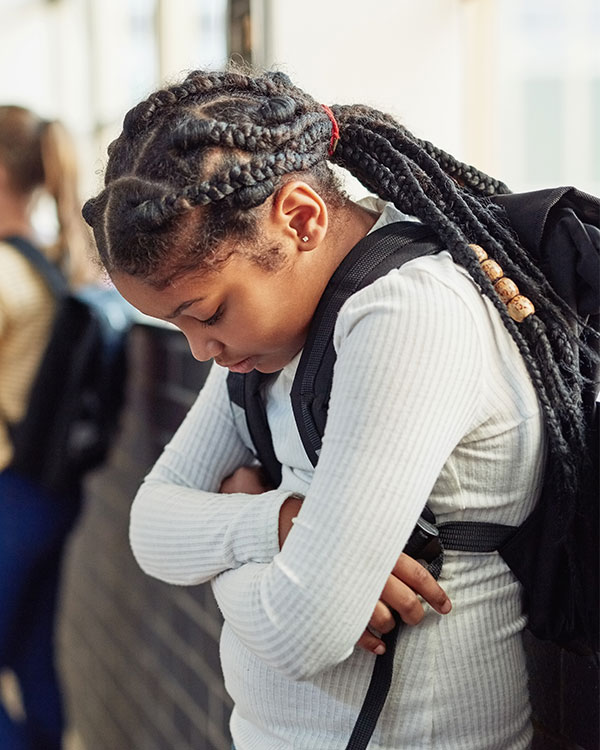 Student crossing arms and looking down